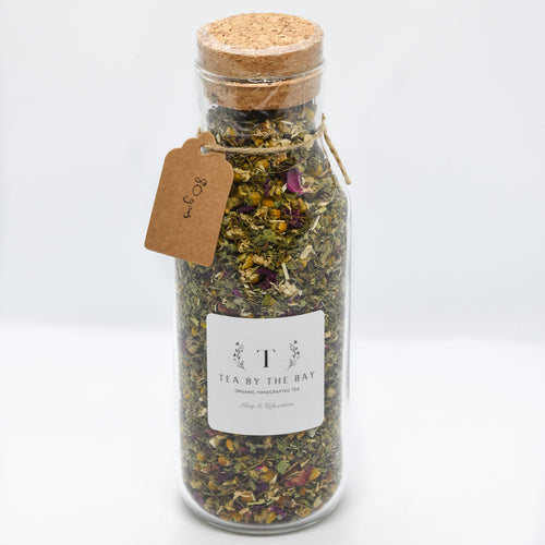 organic sleep and relaxation tea in a glass jar bottle passionflower chamomile rose petals peppermint orange peel 